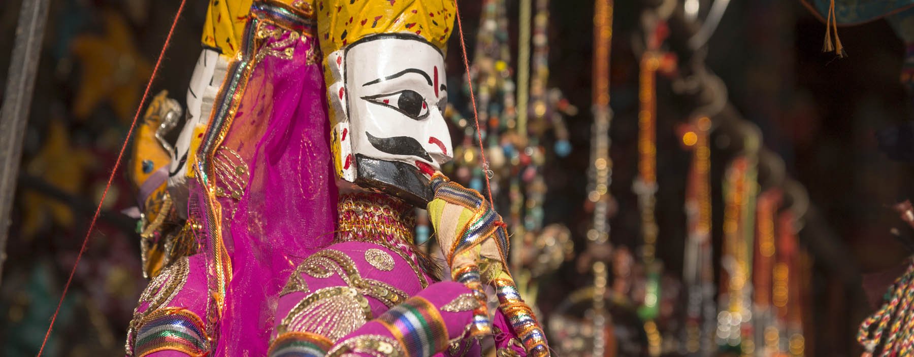 in, pushkar, puppet hanging display in shopfront.jpg